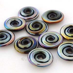 May include: Ten iridescent glass beads with a black swirl design. The beads are round and have a hole in the center. They are perfect for jewelry making.