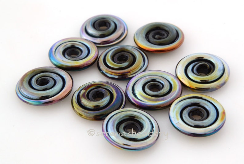 May include: Ten iridescent glass beads with a black swirl design. The beads are round and have a hole in the center. They are perfect for jewelry making.