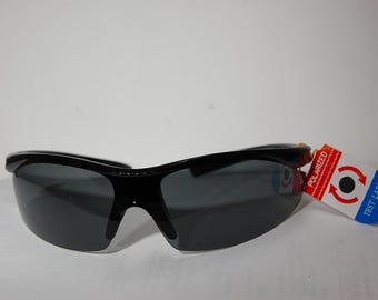 May include: Black sunglasses with gray lenses and a black frame. The sunglasses have a tag attached that says "Polarized" and "Test Label".
