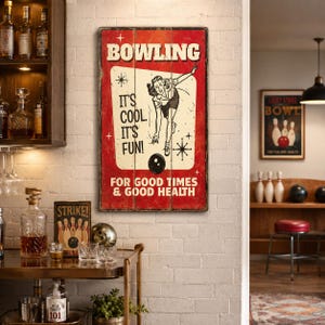 May include: A rectangular wall sign with a distressed red background featuring a vintage illustration of a person bowling. The text reads BOWLING, IT'S COOL. IT'S FUN!, and FOR GOOD TIMES & GOOD HEALTH. The design includes star accents and a cream panel.
