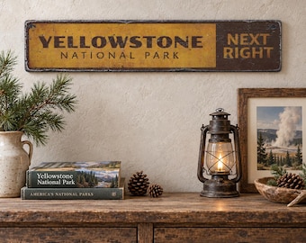 May include: A rectangular metal sign with a distressed yellow and dark brown finish featuring the text YELLOWSTONE NATIONAL PARK NEXT RIGHT. The sign has a weathered appearance with dark edges and bold, dark lettering against a yellow background.