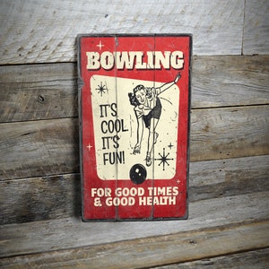 a bowling sign hanging on a wooden wall