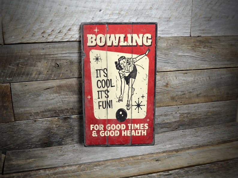a bowling sign hanging on a wooden wall