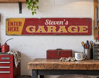 May include: A rectangular horizontal wall sign with a distressed red and yellow finish. The left side features the yellow text ENTER HERE, while the right side displays the white script text Steven's above the large yellow block text GARAGE.