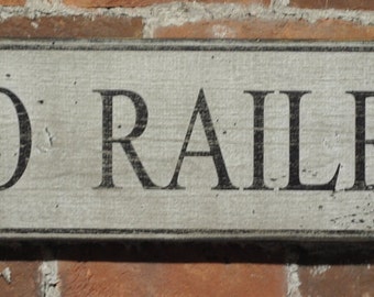 May include: A weathered wooden sign with black lettering that reads "B&O RAILROAD".