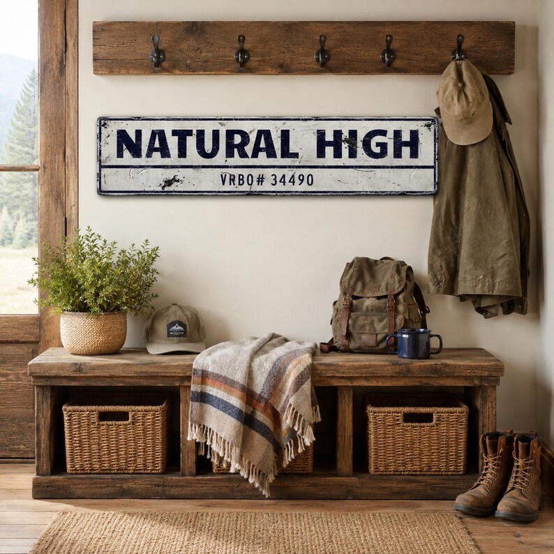 May include: A rectangular metal sign with a distressed white finish and black lettering that reads NATURAL HIGH and VRBQ# 34490. The sign features a thin black border and a weathered, vintage-inspired appearance with visible dark scuff marks.