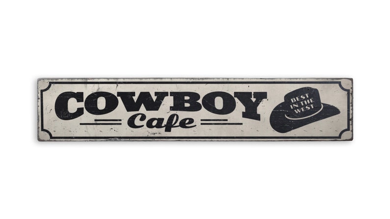 a metal sign that says cowboy cafe