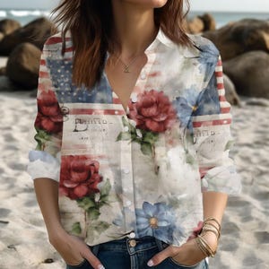 May include: Button-down shirt with a floral and American flag design. The shirt features red roses, blue flowers, and a faded musical score print. The long-sleeved shirt has a classic collar and is buttoned down the front.