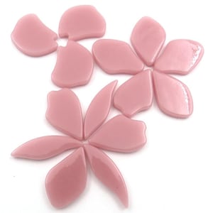 May include: Pink glass flower petals arranged on a white background. The petals vary in shape and size, creating a floral design. The glass has a glossy finish, reflecting light. Ideal for mosaic art or craft projects.