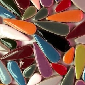 May include: Assortment of colourful ceramic teardrop-shaped tiles in various shades of blue, green, red, purple, orange, yellow, and brown.