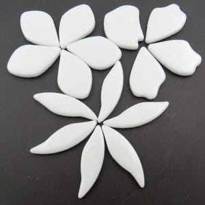 May include: A set of white glass flower petals and leaves, perfect for crafting and mosaic projects.