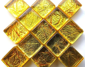 May include: A set of 12 gold-toned square tiles with a textured surface. The tiles are arranged in a diamond pattern.