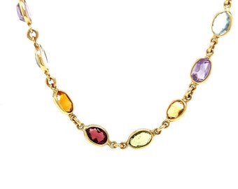 May include: A gold chain necklace with oval-shaped gemstones in various colors, including amethyst, aquamarine, citrine, peridot, and garnet.