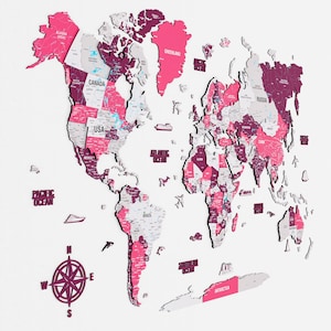 May include: A pink and purple wooden world map with country names labeled. The map includes a compass rose and is mounted on a white background. The Pacific and Atlantic Oceans are labeled.