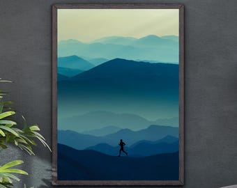 May include: Framed art print featuring a silhouette of a runner on a mountain ridge. The artwork depicts layers of blue mountains under a pale yellow sky. The frame is a dark brown color, and the overall theme is nature and fitness.