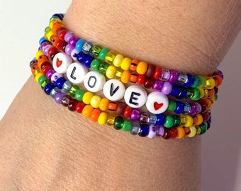 Love is love pride rainbow bracelet set. stacked set of 4 rainbow seed bead bracelets w love word and hearts. Kids thru adult size bracelets