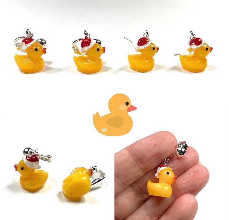 May include: Yellow rubber ducky earrings with a red Santa hat. The earrings are silver and have a hook closure.