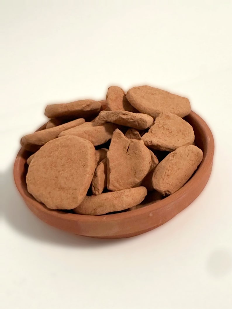 a bowl filled with rocks sitting on top of a table
