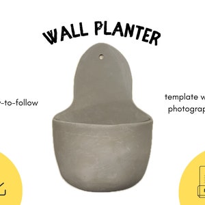 May include: A grey ceramic wall planter with a hole in the top for hanging. The planter is shaped like a teardrop and has a wide opening at the top. The text "WALL PLANTER" is written in black letters above the planter. The text "easy-to-follow" is written in black letters below the planter on the left side. The text "template with photographs" is written in black letters below the planter on the right side. A yellow square with a download arrow icon is in the lower left corner. A yellow square with a white PDF icon is in the lower right corner.
