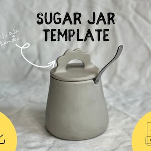 Könnte beinhalten: Eine graue Zuckerdose aus Keramik mit Deckel und kleinem Griff. Der Deckel hat einen gewellten Rand. Ein kleiner Löffel liegt in der Dose. Der Text "SUGAR JAR TEMPLATE" steht über der Dose.