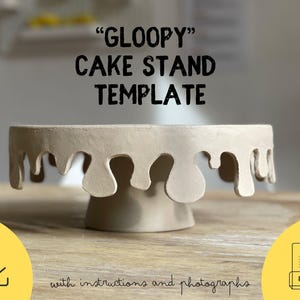 May include: A beige ceramic cake stand with a unique design. The stand features a circular top with a dripping edge and a cylindrical base. The text "GLOOPY" CAKE STAND TEMPLATE is displayed above the stand.