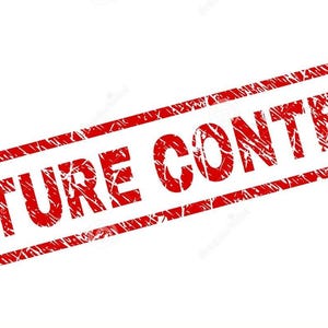 May include: A red rectangular stamp with the words "NATURE CONTENT" in a bold, distressed font. The stamp has a textured appearance, suggesting it has been used. The text is centered within the rectangle.