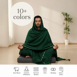 Oversize dark green wool blend meditation shawl, perfect as a cozy winter blanket or wrap. Shows a person meditating, highlighting its use for yoga, relaxation, and gifting. Available in 10+ colors.