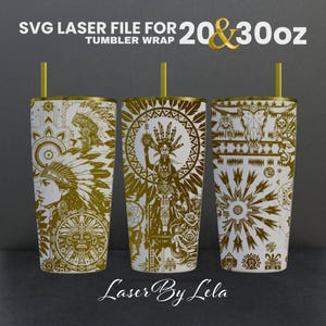 May include: Three white tumblers with gold designs. The designs feature Native American inspired patterns, including feathers, geometric shapes, and a woman's face. The tumblers are 20 and 30 ounces. The text "Laser By Lela" is at the bottom of the image.