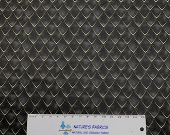 May include: Black fabric with a repeating pattern of gold-colored, scale-like shapes. The fabric has a subtle texture and a gradient effect, with lighter tones in the center of each scale. A ruler with text is at the bottom.