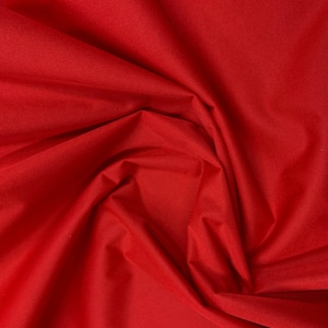 May include: Close-up of a vibrant red fabric with soft folds and subtle texture. The material appears to be a lightweight textile, possibly suitable for apparel or decorative projects. The color is a solid, saturated red.