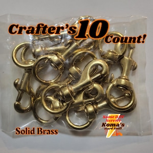 May include: A bag of 10 solid brass swivel snap hooks. The hooks are gold in color and are packaged in a clear plastic bag. The bag has the text "Crafter's 10 Count!" and "Solid Brass" printed on it.