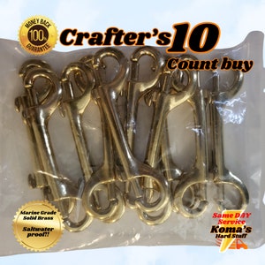 May include: A package of 10 gold-colored solid brass swivel snap hooks. The package is labeled "Crafter's 10 Count buy" and "Marine Grade Solid Brass Saltwater proof!!".