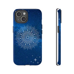 May include: A smartphone case with a dark blue, starry background and a white mandala design. The case has a black camera module and buttons. The side view shows a white border. The design includes four white stars.