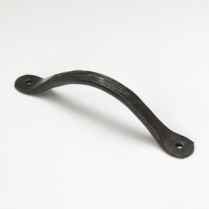 May include: A black, curved metal handle with a textured surface. The handle has a rounded shape and features two mounting holes, one at each end. The hardware is designed for use on doors, drawers, or cabinets.
