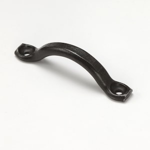 May include: A black, curved cabinet pull with a textured finish. The handle has a rounded arch and is attached to two rectangular mounting plates with circular holes. The hardware is designed for easy installation and adds a rustic touch.