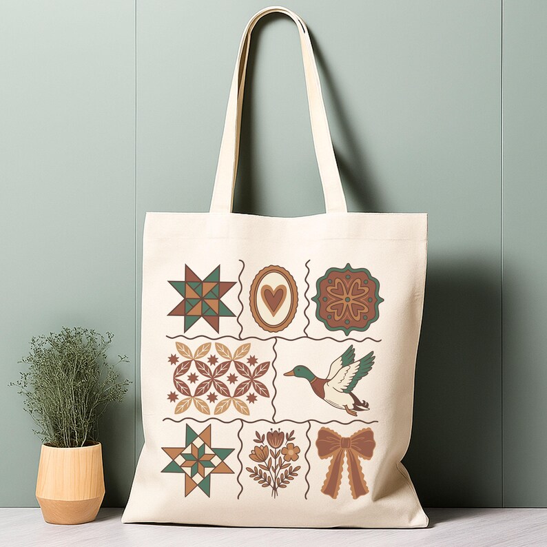May include: Cream tote bag with a patchwork design. The bag features illustrations of stars, hearts, flowers, a duck, and a bow. The bag has long handles for carrying. The bag's design is reminiscent of a quilt.