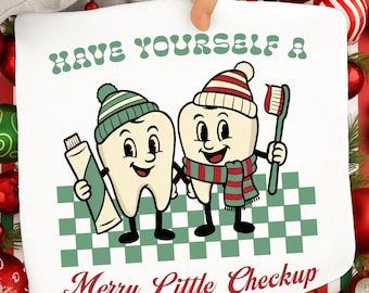 May include: A white graphic featuring two cartoon teeth wearing winter hats and scarves, holding a tube of toothpaste and a toothbrush. The text reads "Have Yourself a Merry Little Checkup" in green and red.