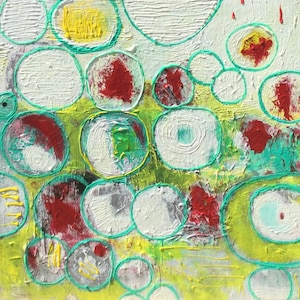 May include: Abstract painting with a green, yellow, and white background. The painting features a variety of overlapping circles in different sizes and colors, including red, white, and green.