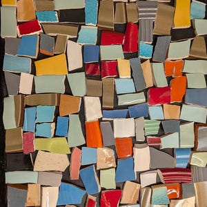 May include: A mosaic of irregularly shaped ceramic pieces in various colors, including red, blue, yellow, and green, arranged on a black background. The pieces vary in size and shape, creating a textured, abstract design. The mosaic is a decorative art piece.