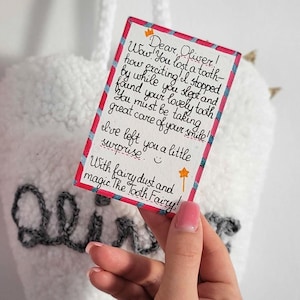 May include: A handwritten note from the Tooth Fairy to Oliver, saying "Wow! You lost a tooth- how exciting! I stopped by while you slept and found your lovely tooth. You must be taking great care of your smile! I've left you a little surprise. With fairy dust and magic. The Tooth Fairy!"