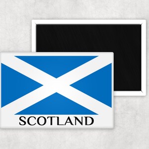 May include: A white magnet with a blue and white Scottish flag and the word "SCOTLAND" printed in black.