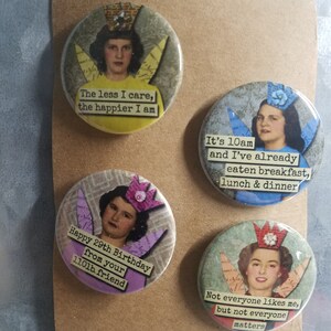 May include: Four round buttons with colorful images and text. The text on the buttons reads: "The less I care, the happier I am", "It's 10am and I've already eaten breakfast, lunch & dinner", "Happy 29th Birthday from your 110lb friend", and "Not everyone likes me, but not everyone matters".