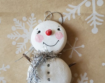 whimsical snowman ornament with tinsel scarf