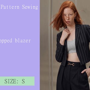 May include: A black cropped blazer with thin white pinstripes, long sleeves, and a notched lapel collar. The text on the image reads PDF Pattern Sewing, Cropped blazer, and SIZE: S. The blazer is worn over a grey crop top and black trousers.