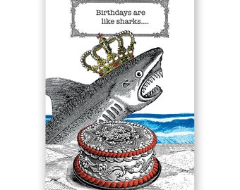 May include: A birthday card featuring a cartoon shark wearing a crown, jumping out of a cake with the text "Birthdays are like sharks..."