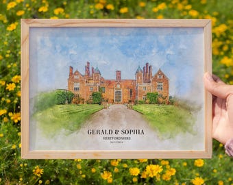 May include: A watercolor painting of a large brick house with a long driveway. The painting is framed in a light wood frame. The text "GERALD & SOPHIA, HERTFORDSHIRE, 28/11/2024" is printed below the image.