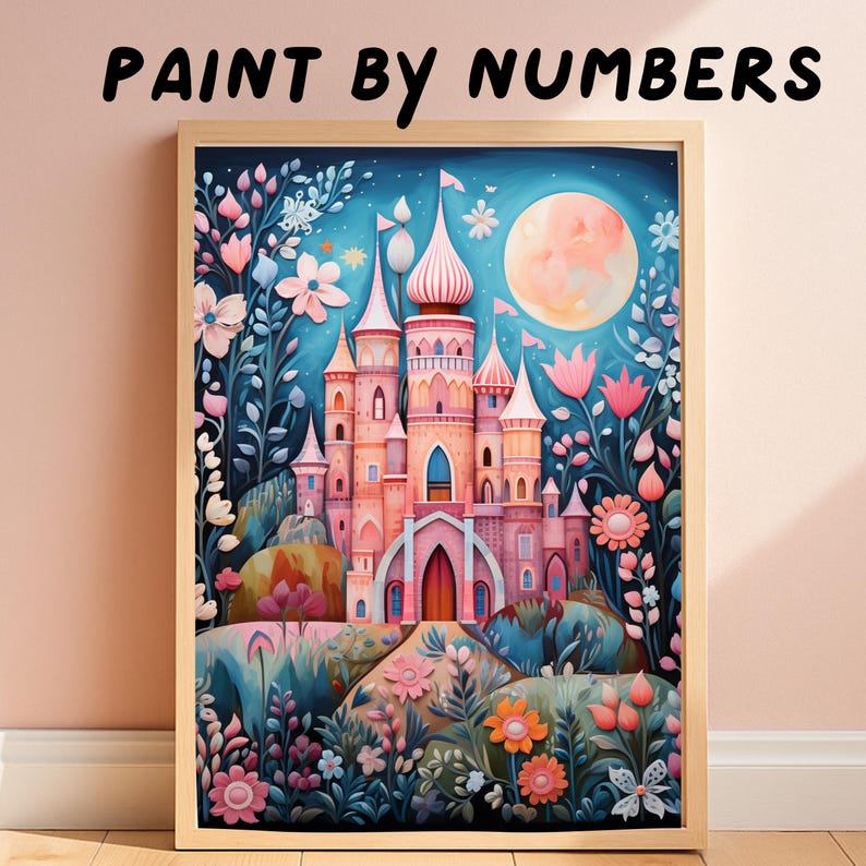 May include: A framed paint by numbers kit featuring a pink castle surrounded by stylized flowers and foliage under a large moon in a blue night sky. The text PAINT BY NUMBERS is printed in black above the rectangular wooden frame.