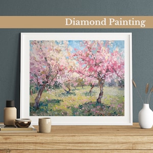 May include: Diamond painting of a landscape with three pink and white flowering trees in a field. The trees are in the foreground and the background is a blue sky with white clouds.