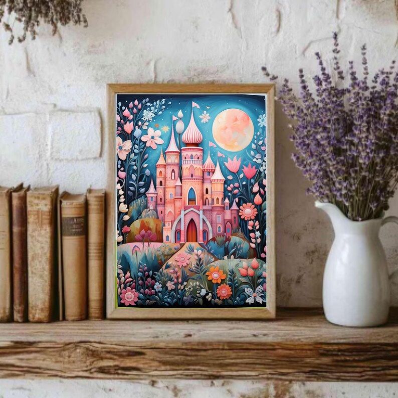 May include: A rectangular framed art print featuring a pink castle with multiple towers and spires, surrounded by stylized flowers and foliage in shades of blue, pink, and orange, set against a dark blue night sky with a large, pale yellow full moon.