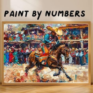 May include: A paint by numbers kit featuring a framed artwork of a rider on a brown horse wearing a sombrero and colorful western attire. The scene depicts a rodeo or festival with a crowd in the background, rendered in a textured, painterly style.
